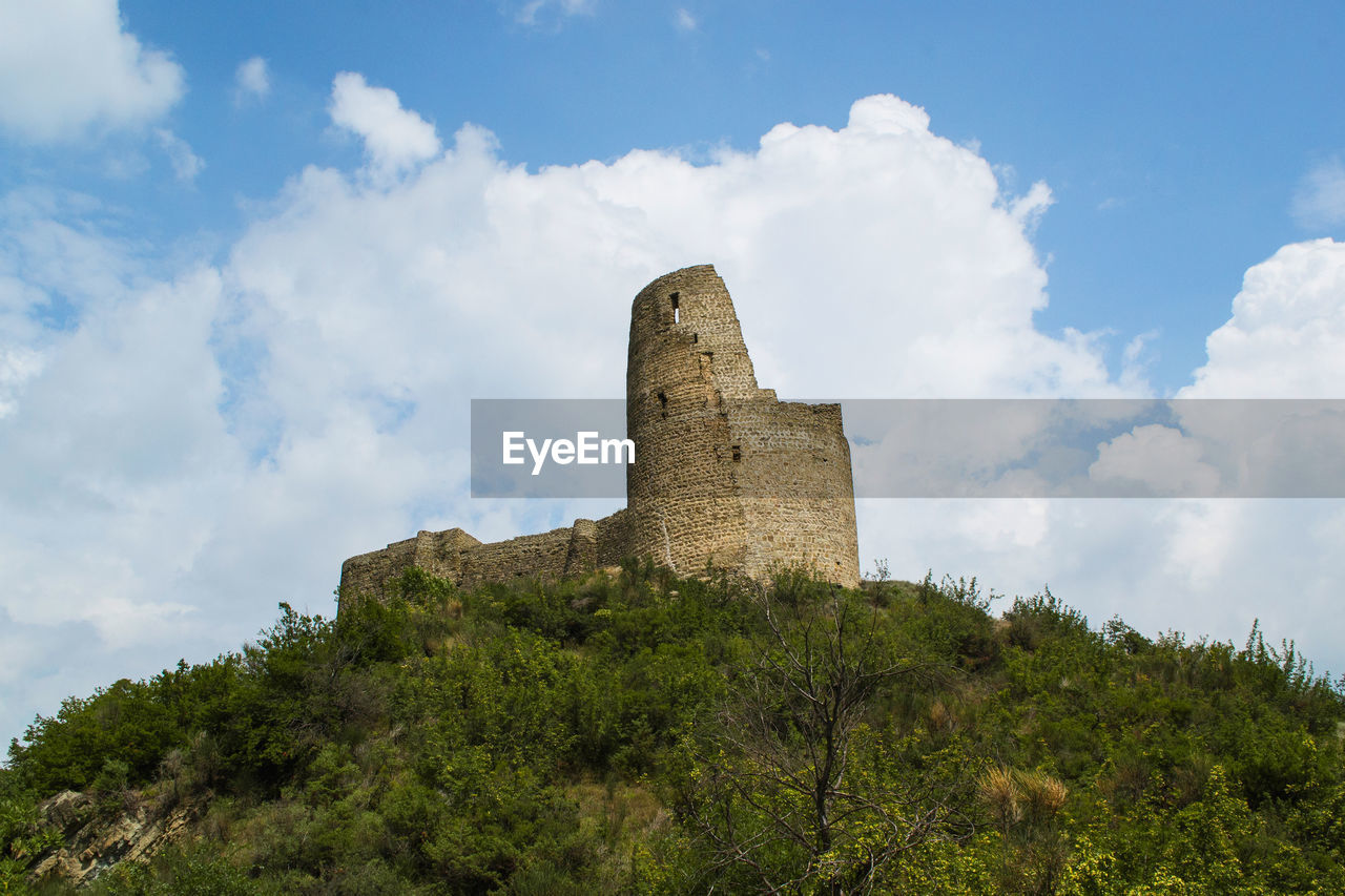 Low angle view of castle against cloudy sky