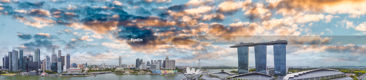 PANORAMIC VIEW OF MODERN BUILDINGS AGAINST SKY