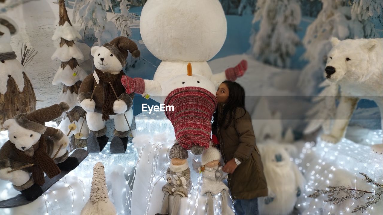 Girl kissing snowman sculpture