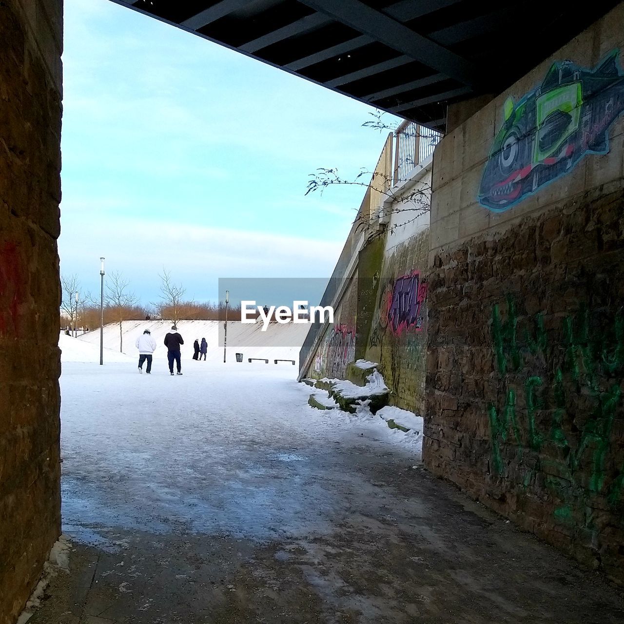 PEOPLE WALKING ON BUILDING WALL