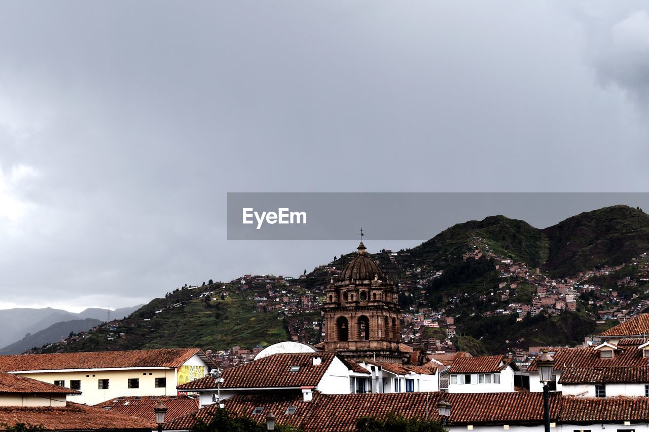 Buildings in town against sky at cuzco