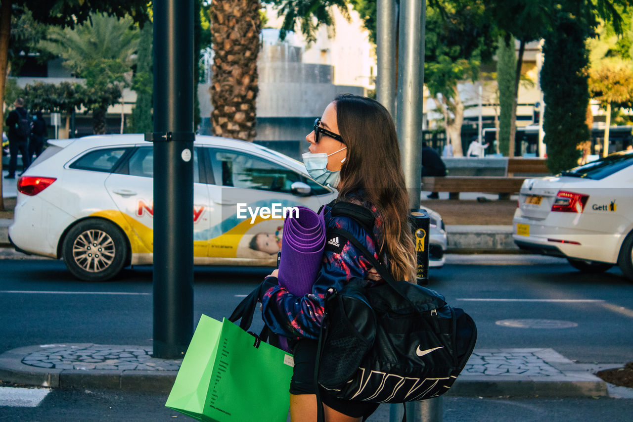 WOMAN ON STREET IN CITY