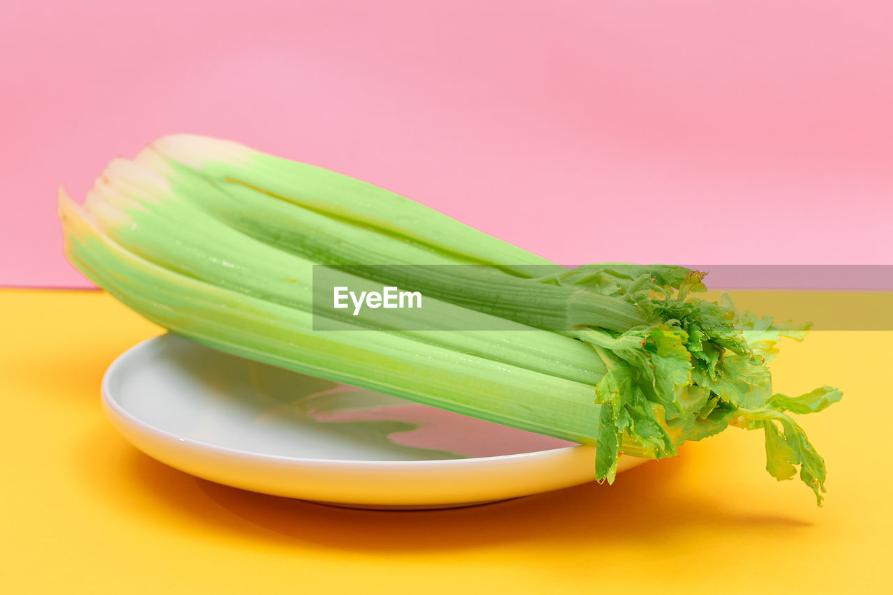 CLOSE-UP OF GREEN CHILI ON TABLE