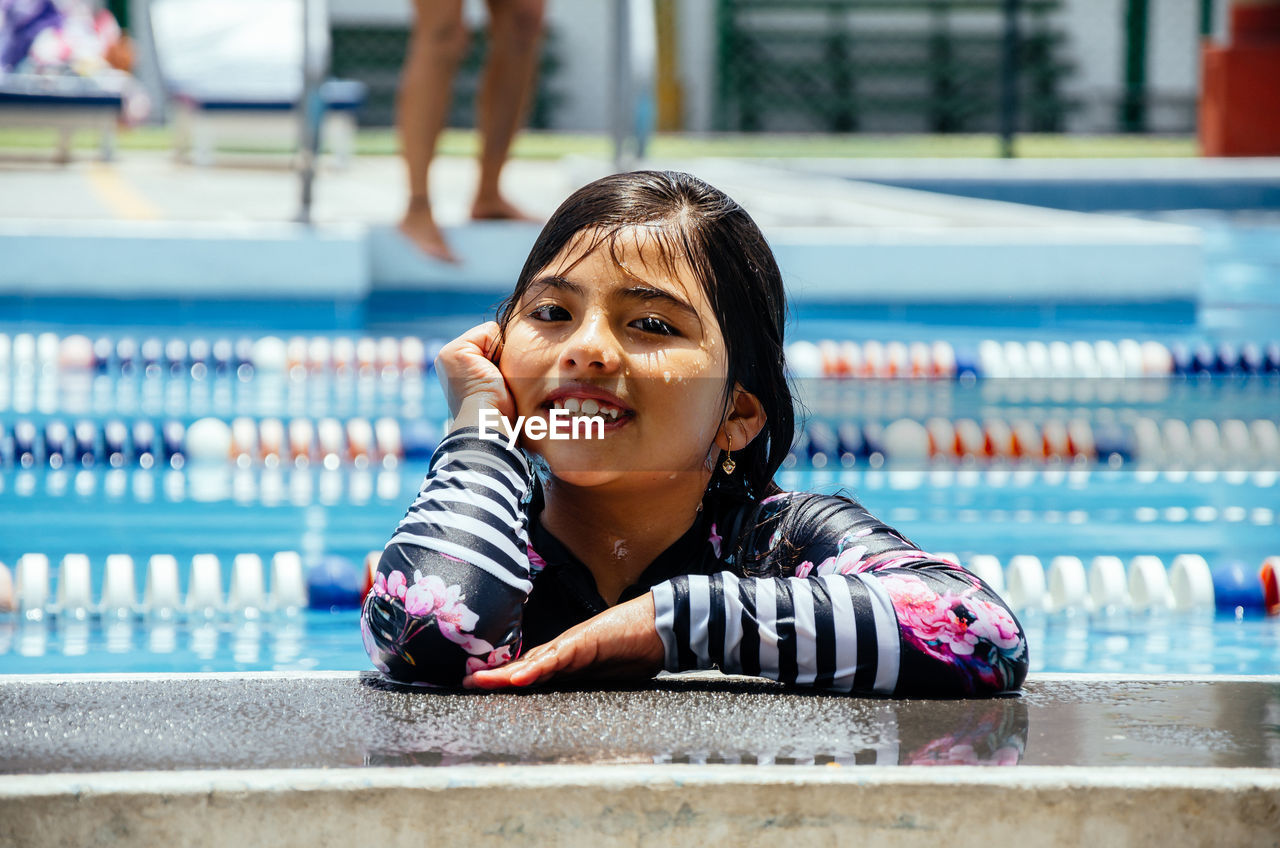 Portrait of smiling girl in swimming pool