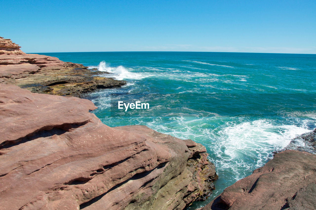 Scenic view of sea against blue sky