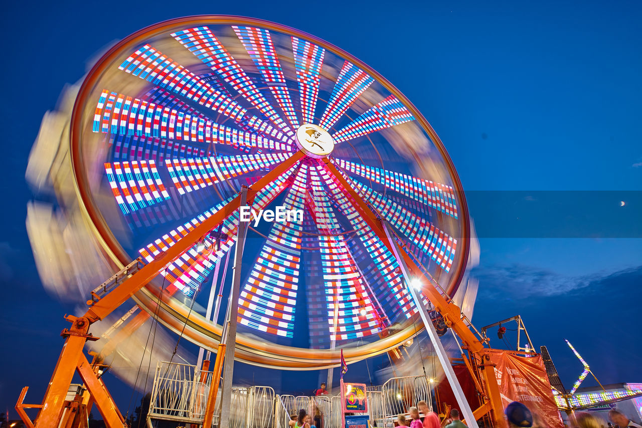 low angle view of ferris wheel against blue sky