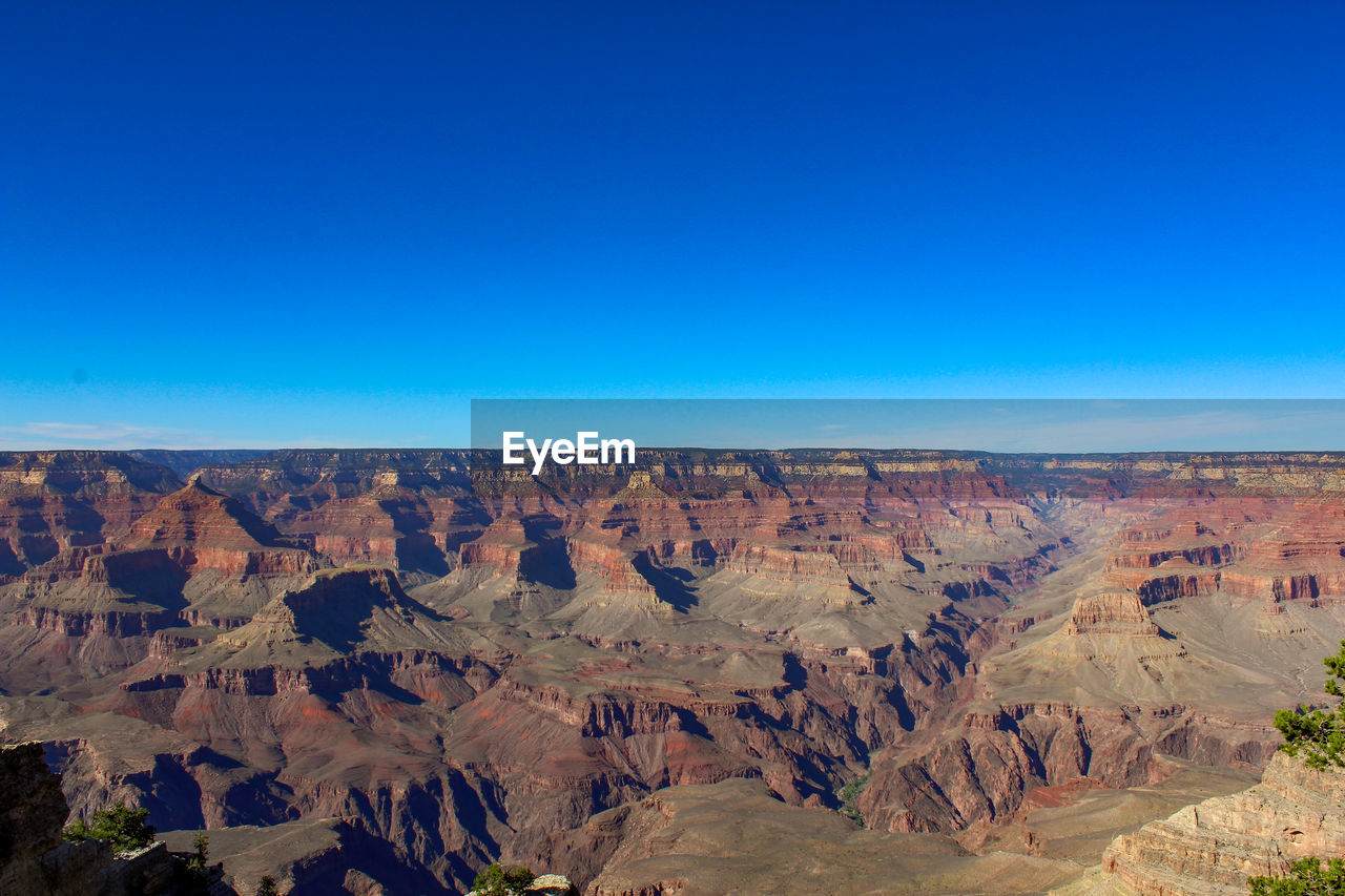 SCENIC VIEW OF DRAMATIC LANDSCAPE AGAINST BLUE SKY