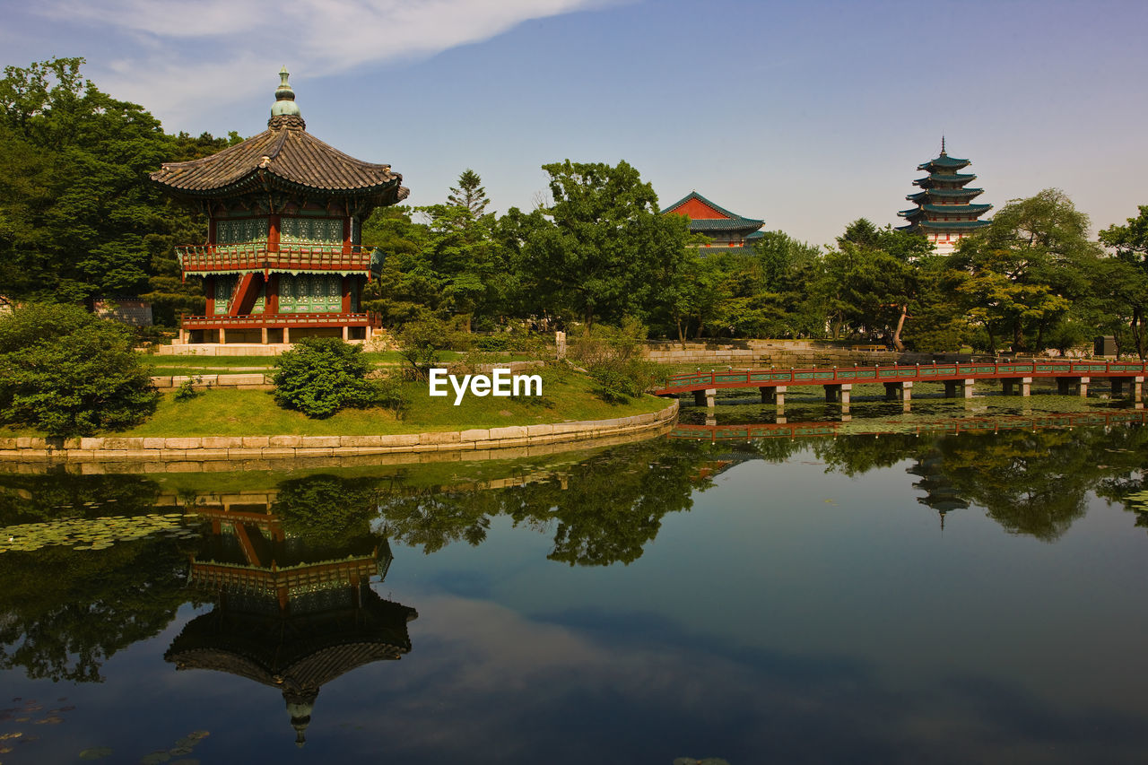 Photo of buildings and lake at the royal palace gyeongbokgung / seoul