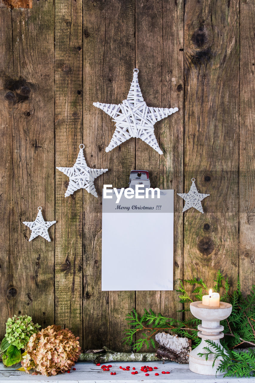 Christmas decorations with clipboard hanging on wooden wall