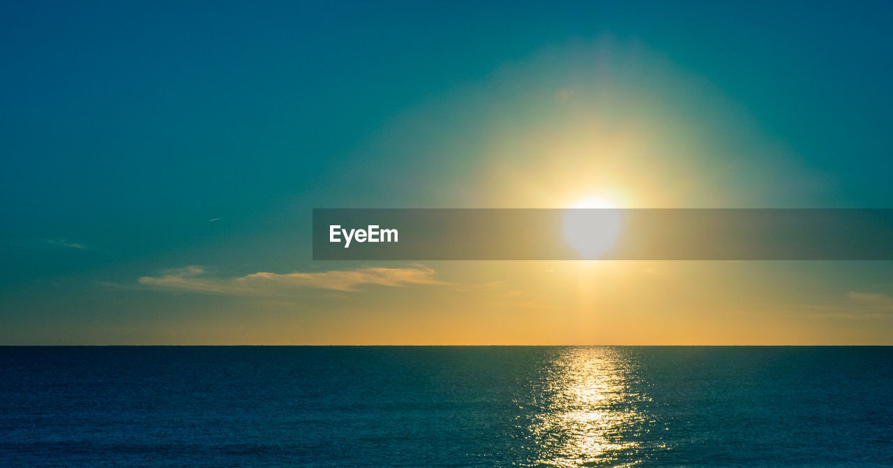 Scenic view of sea against blue sky