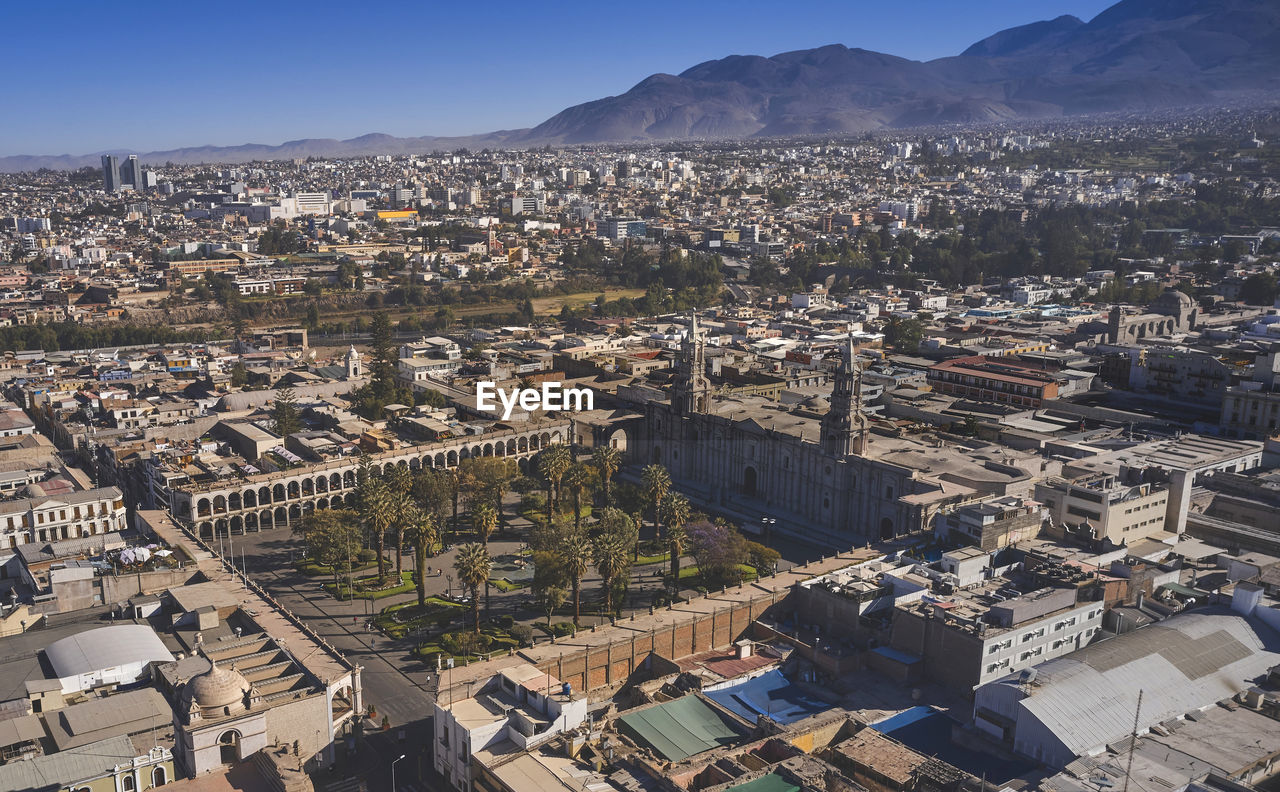 Aerial drone view of arequipa main square and cathedral church, with the misti volcano at sunset.