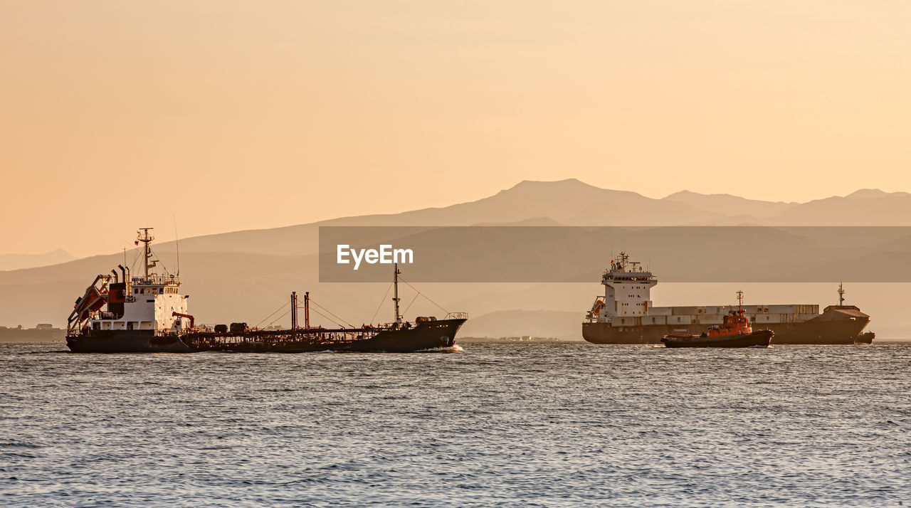 Industrial dry cargo ships on the kamchatka peninsula at sunset