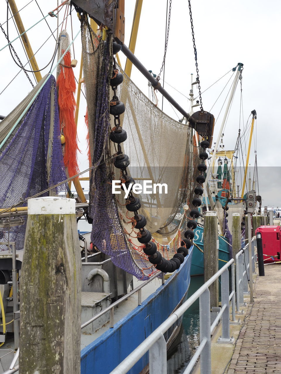 Fishing nets hanging on boat at harbor