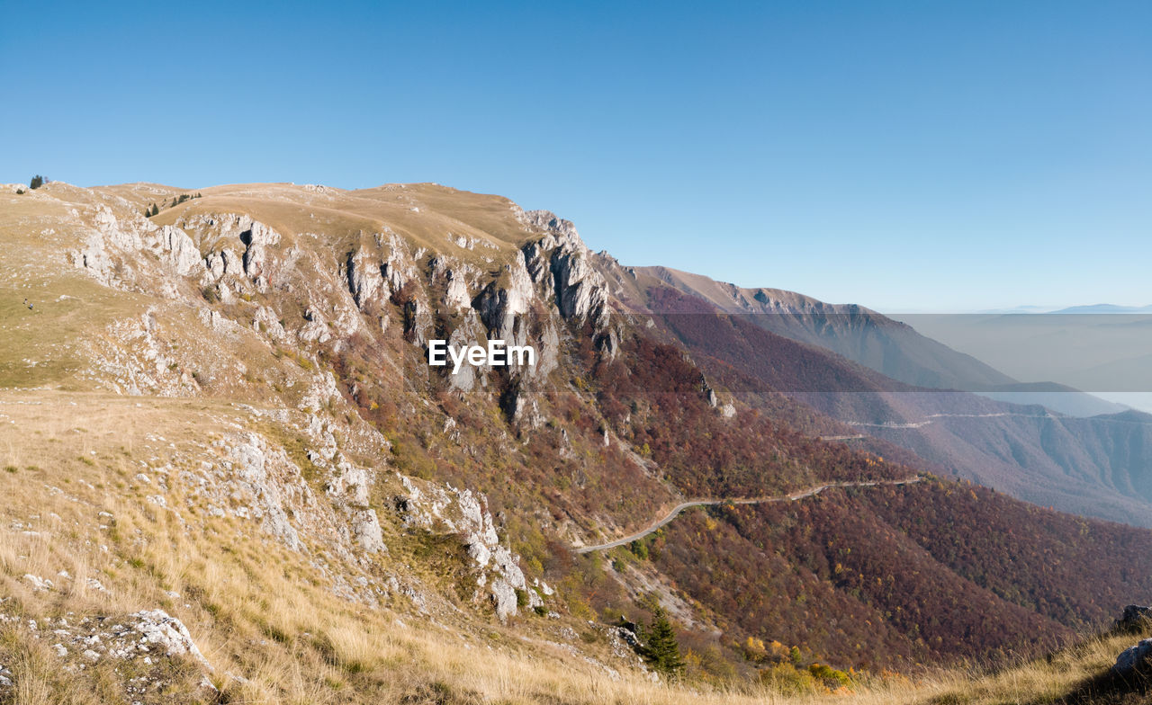 Scenic view of mountains against clear blue sky