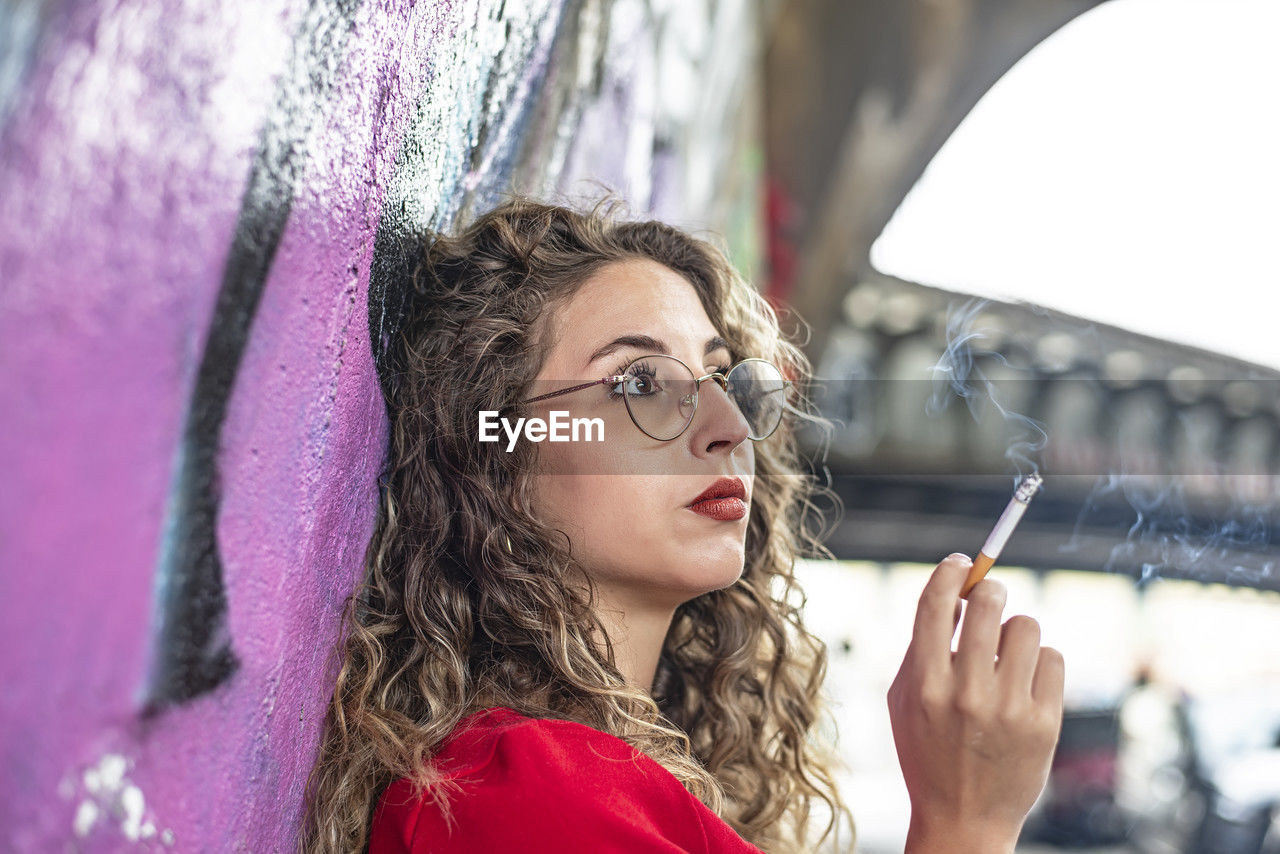 low angle view of young woman with umbrella