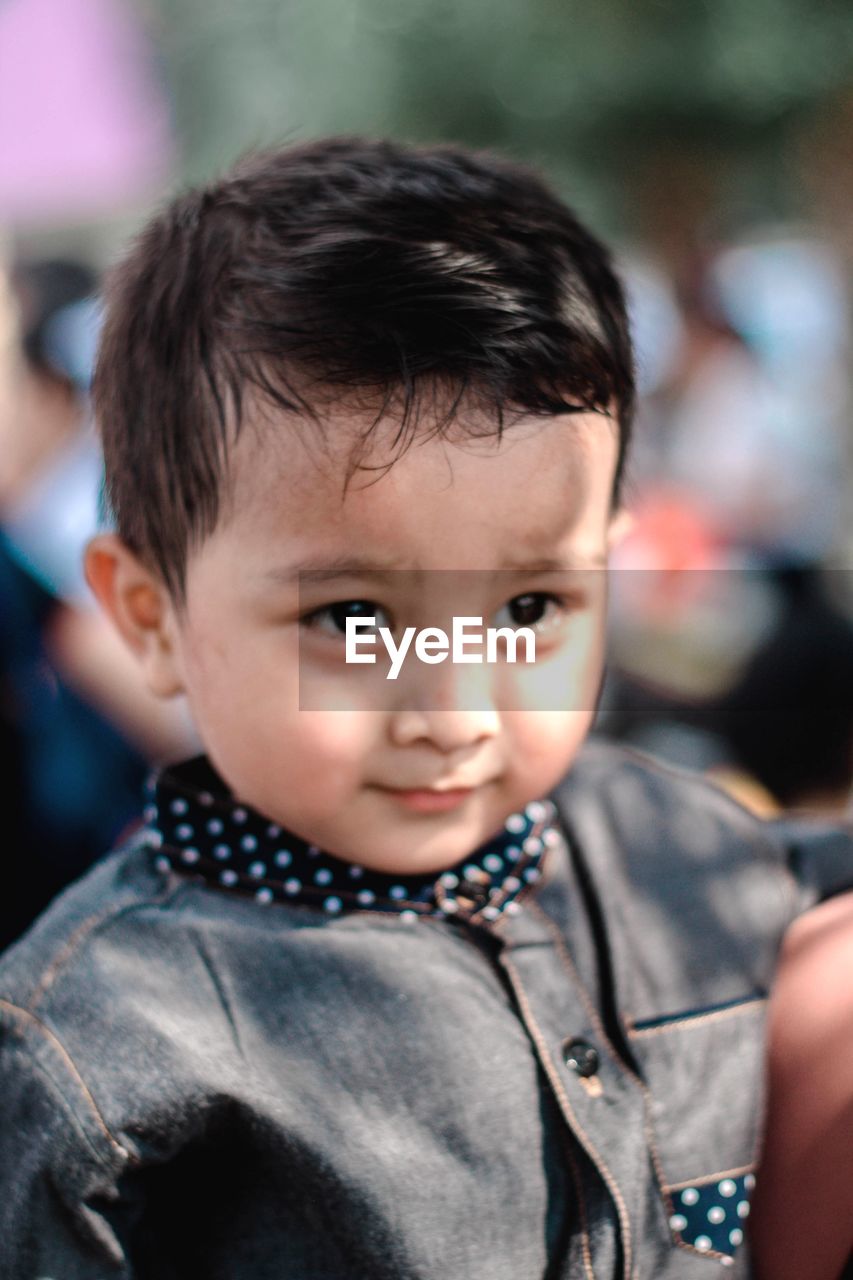 Close-up of cute boy looking away