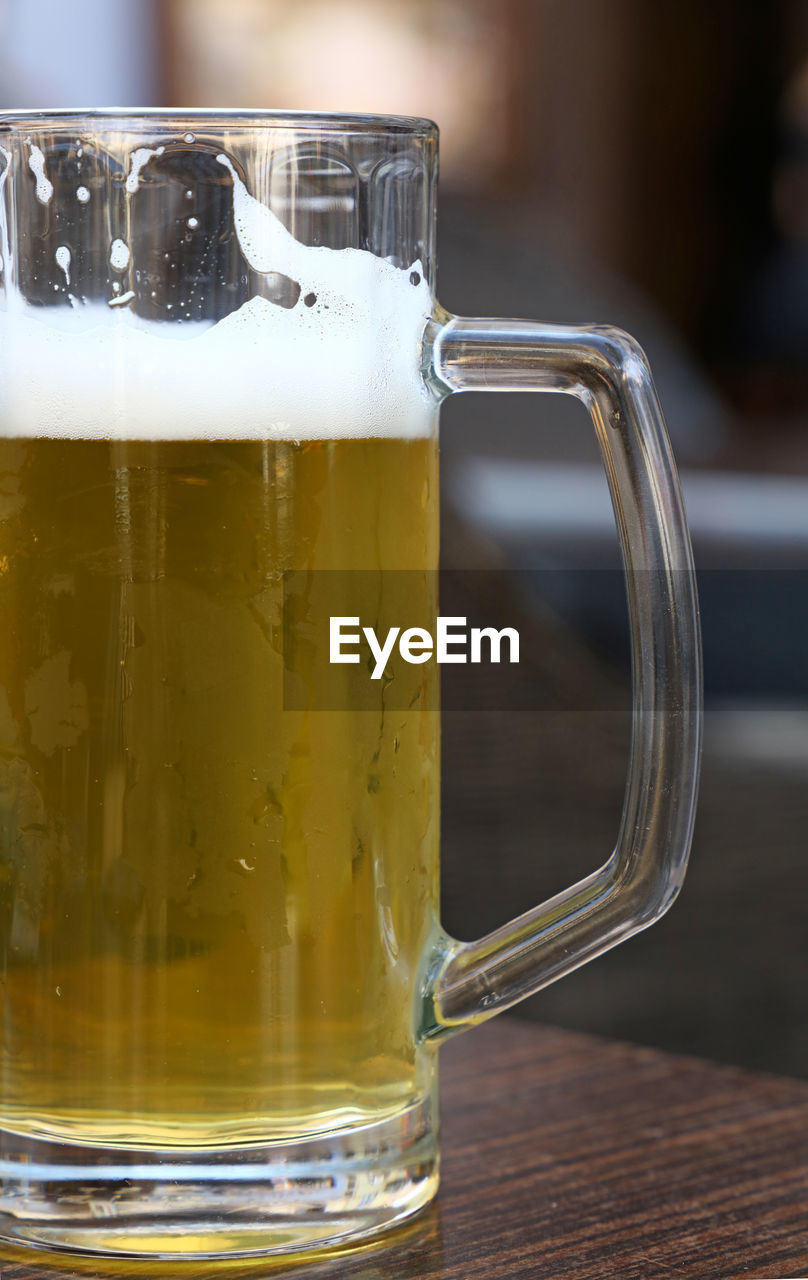 Close-up of draught beer on table