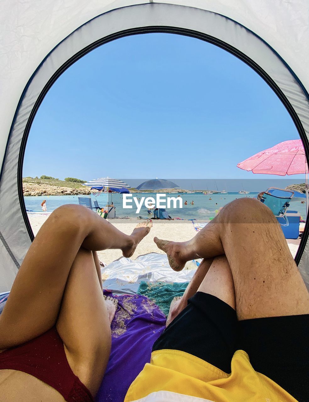 Low section of woman relaxing on beach