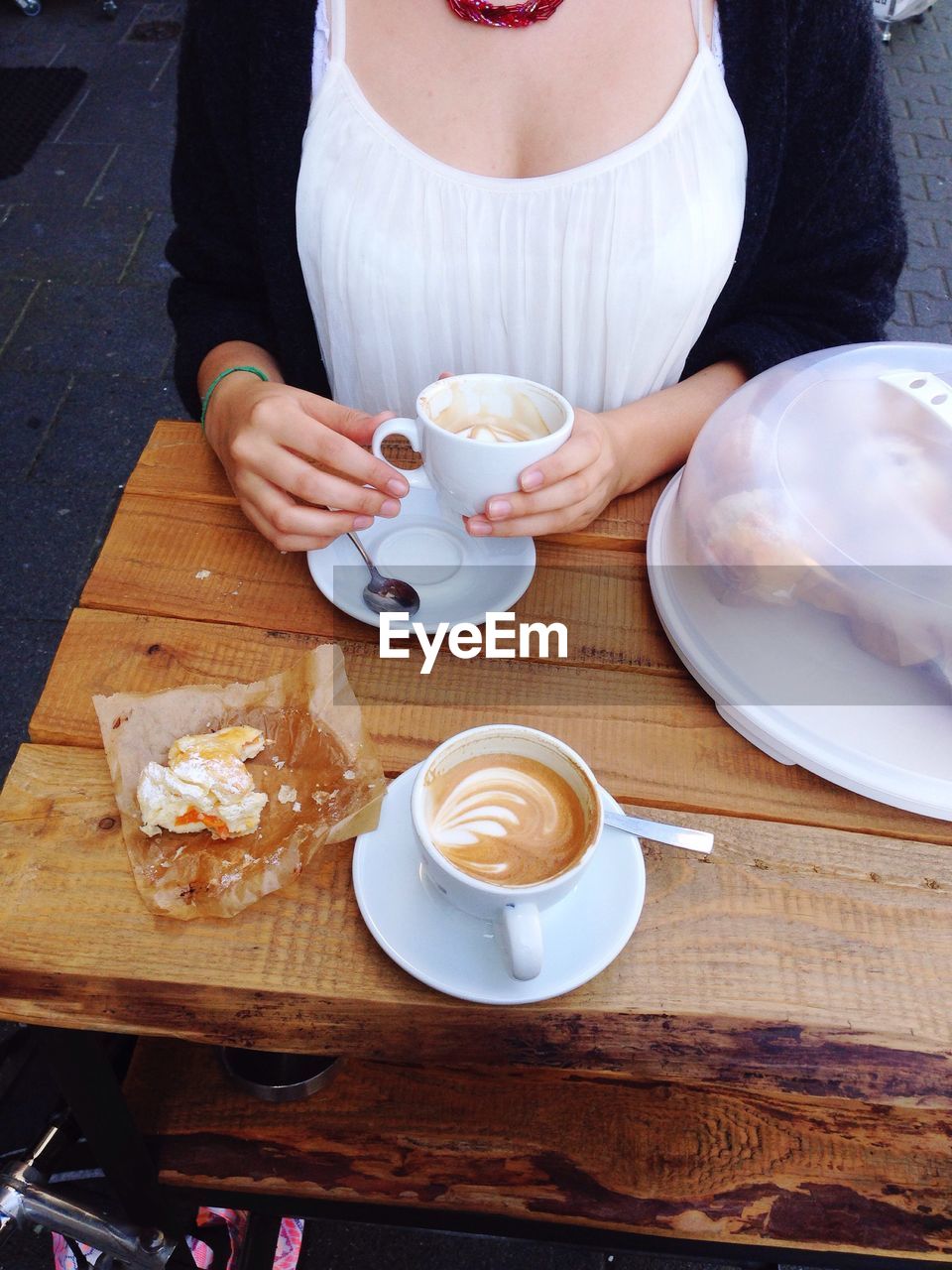 Woman drinking coffee at caf