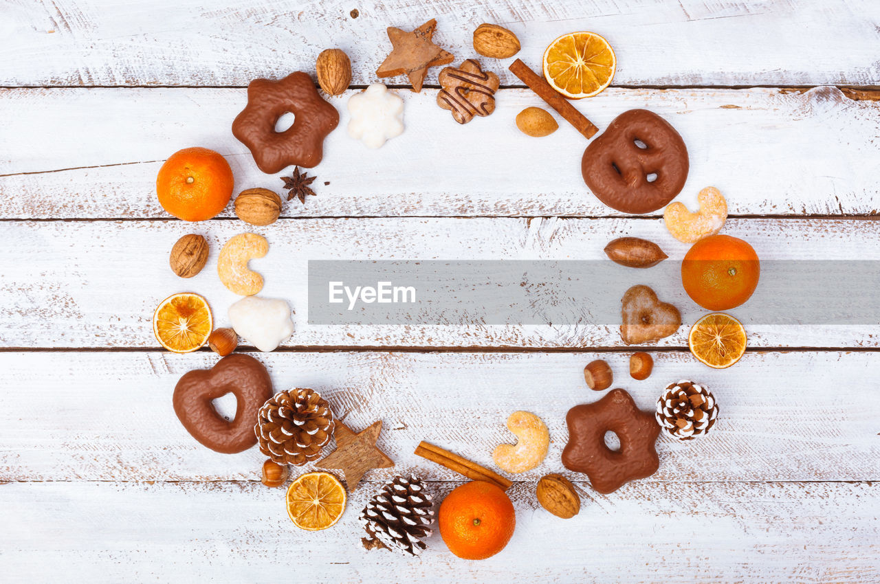 High angle view of cookies and fruits arranging on table
