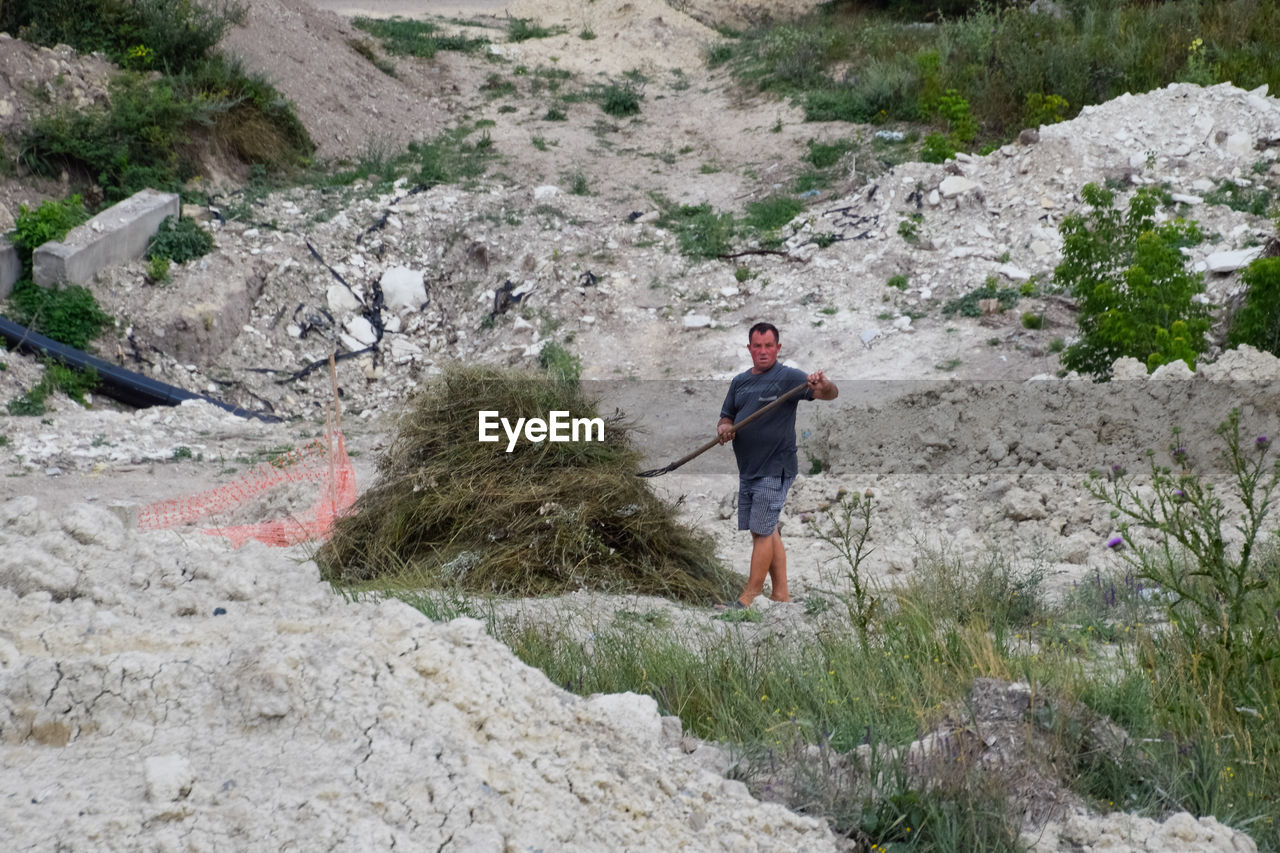 MAN STANDING ON ROCK