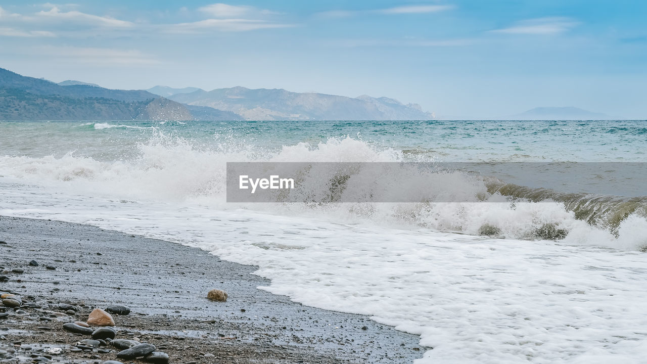 SCENIC VIEW OF SEA WAVES AGAINST SKY