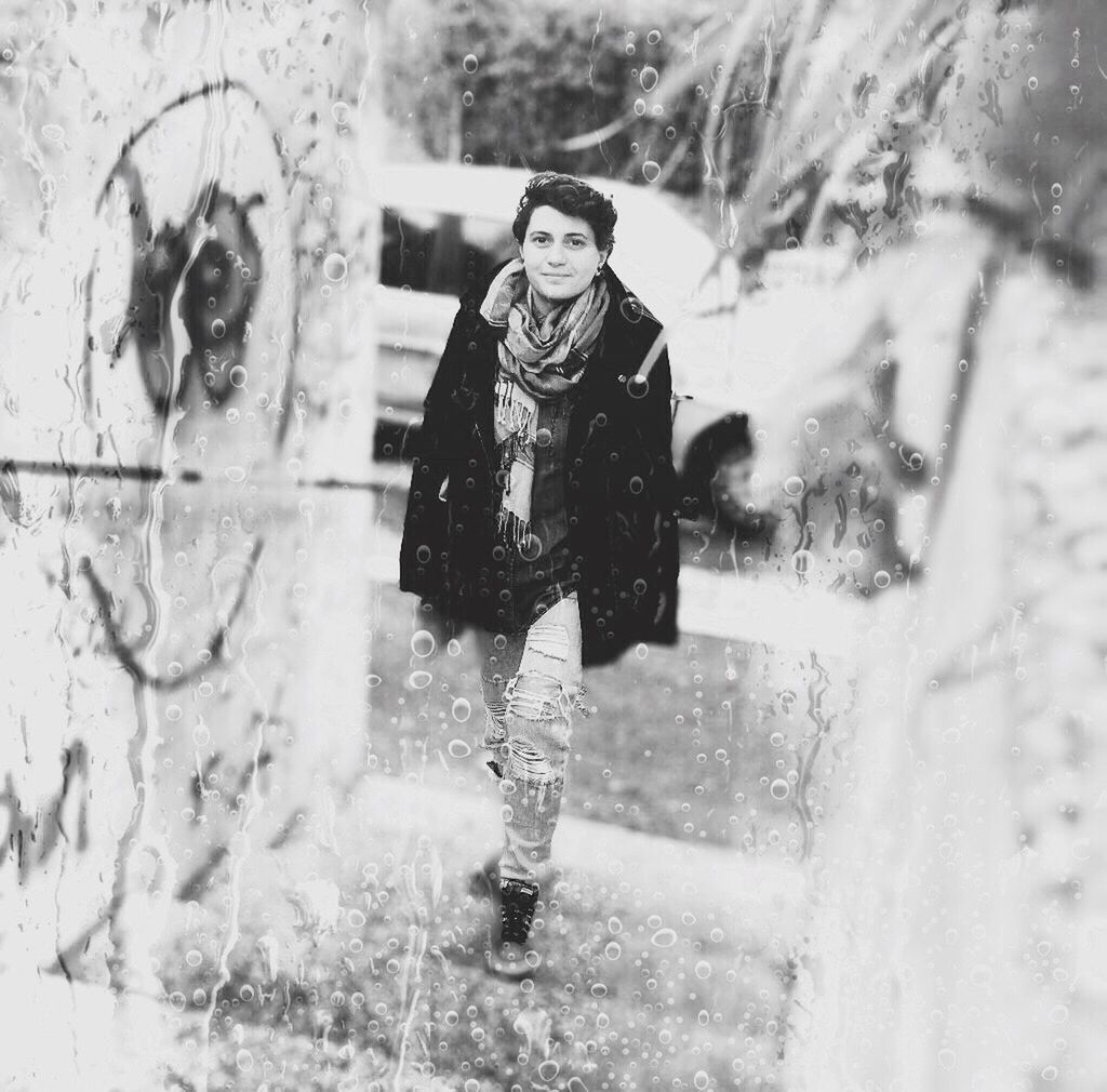 WOMAN STANDING IN WET GLASS DURING WINTER