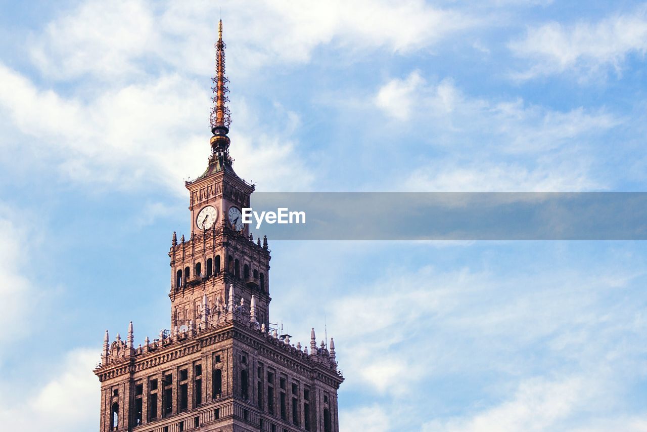 Palace of culture and science against cloudy sky