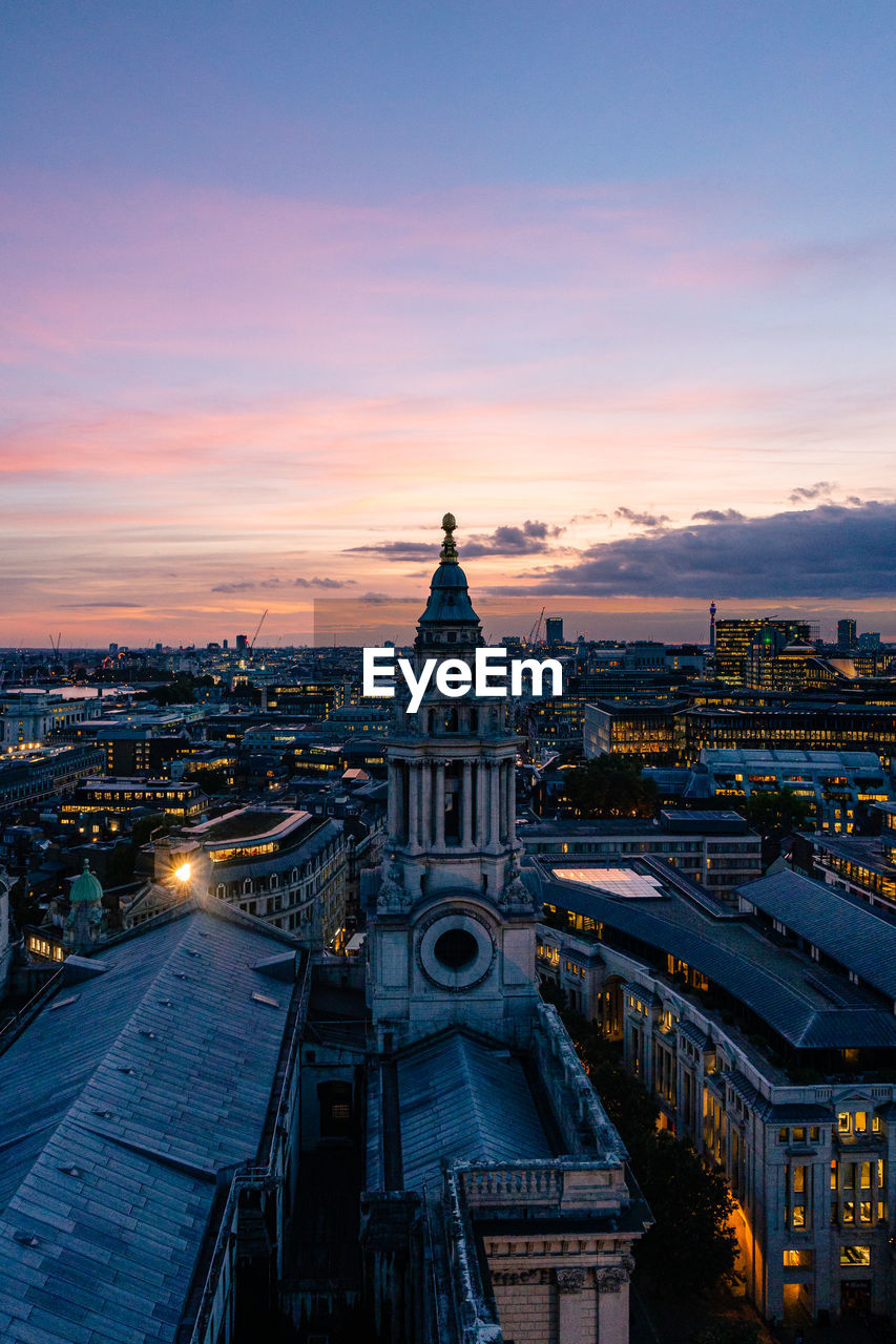 High angle view of illuminated buildings against sky at sunset