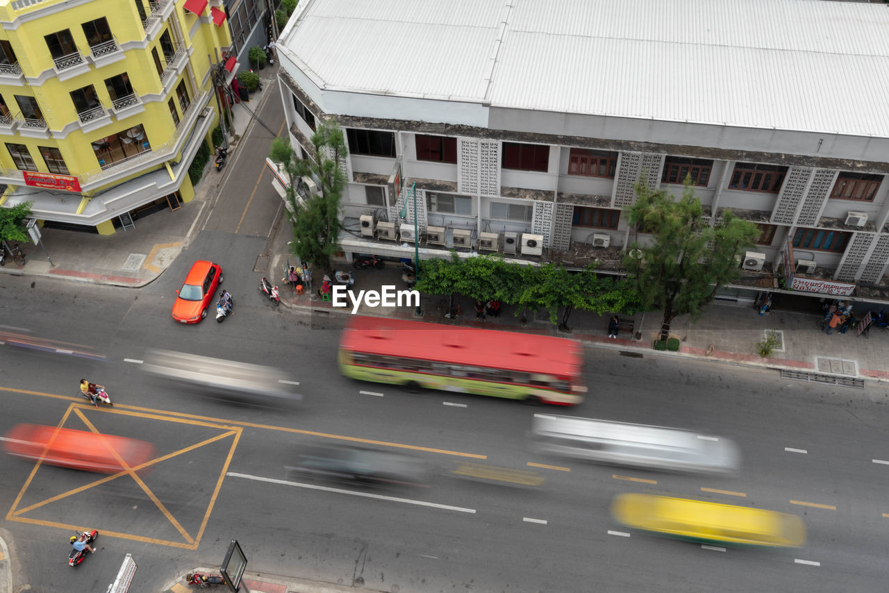 High angle view of vehicles on road along buildings