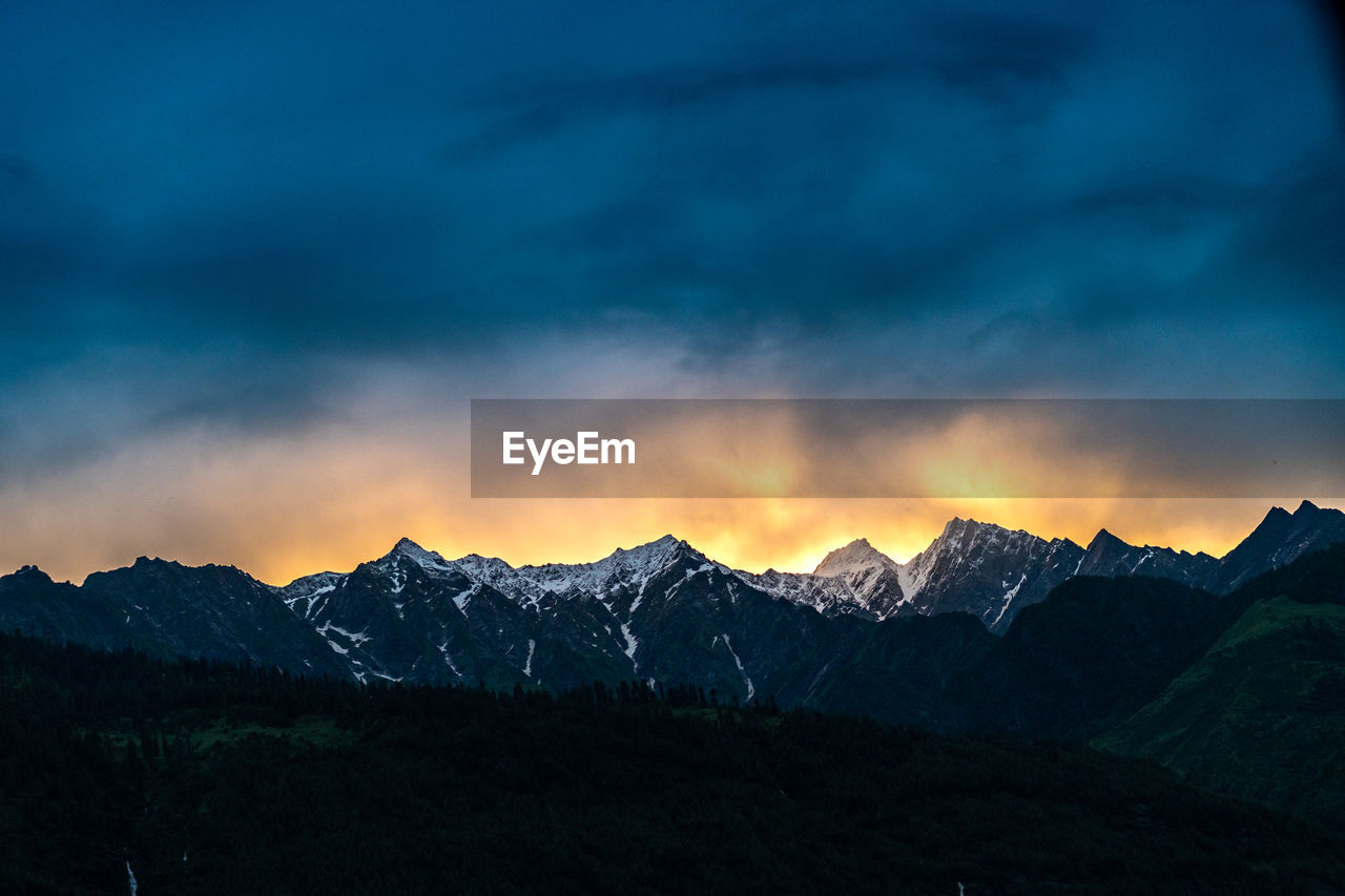 scenic view of silhouette mountains against sky during sunset