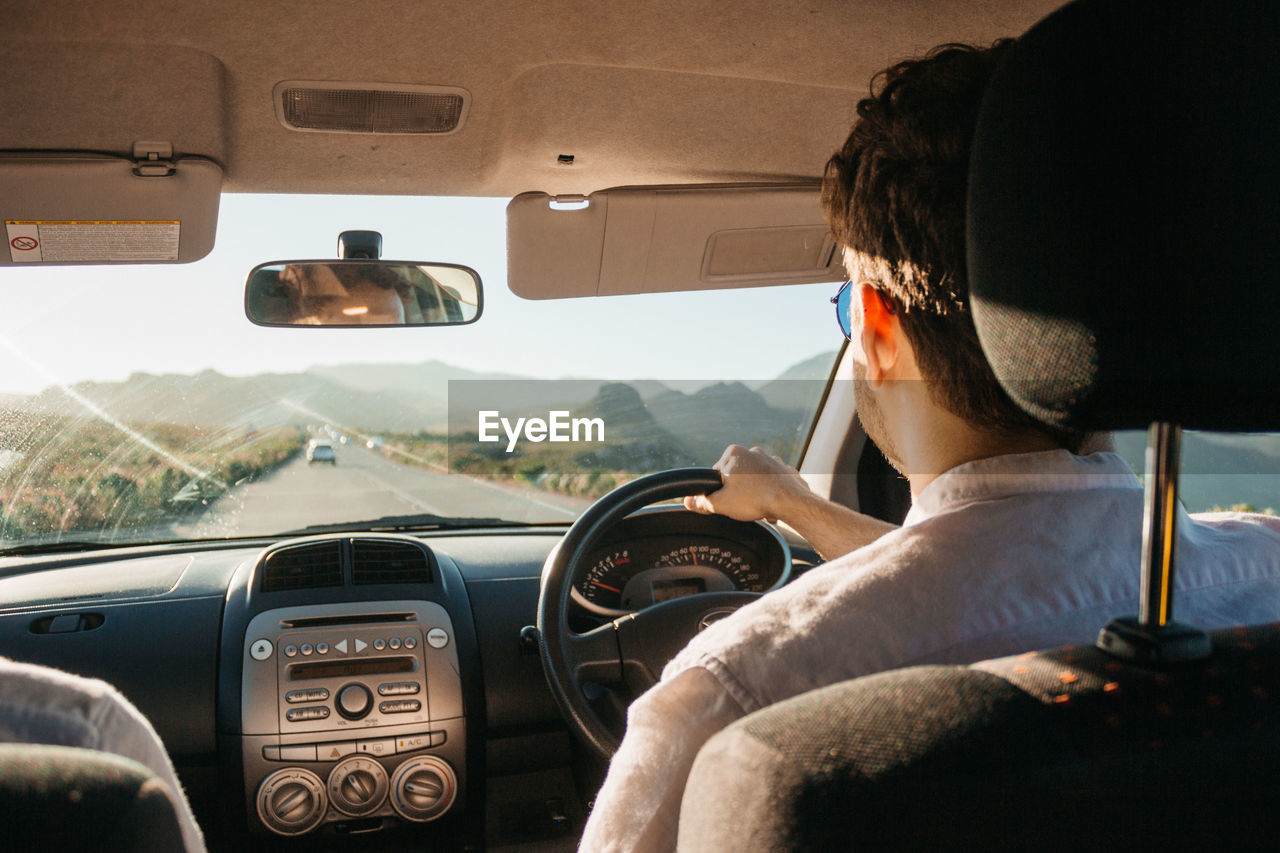 Man driving car during day