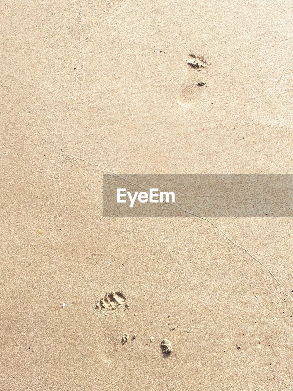 High angle view of footprints on sand at beach