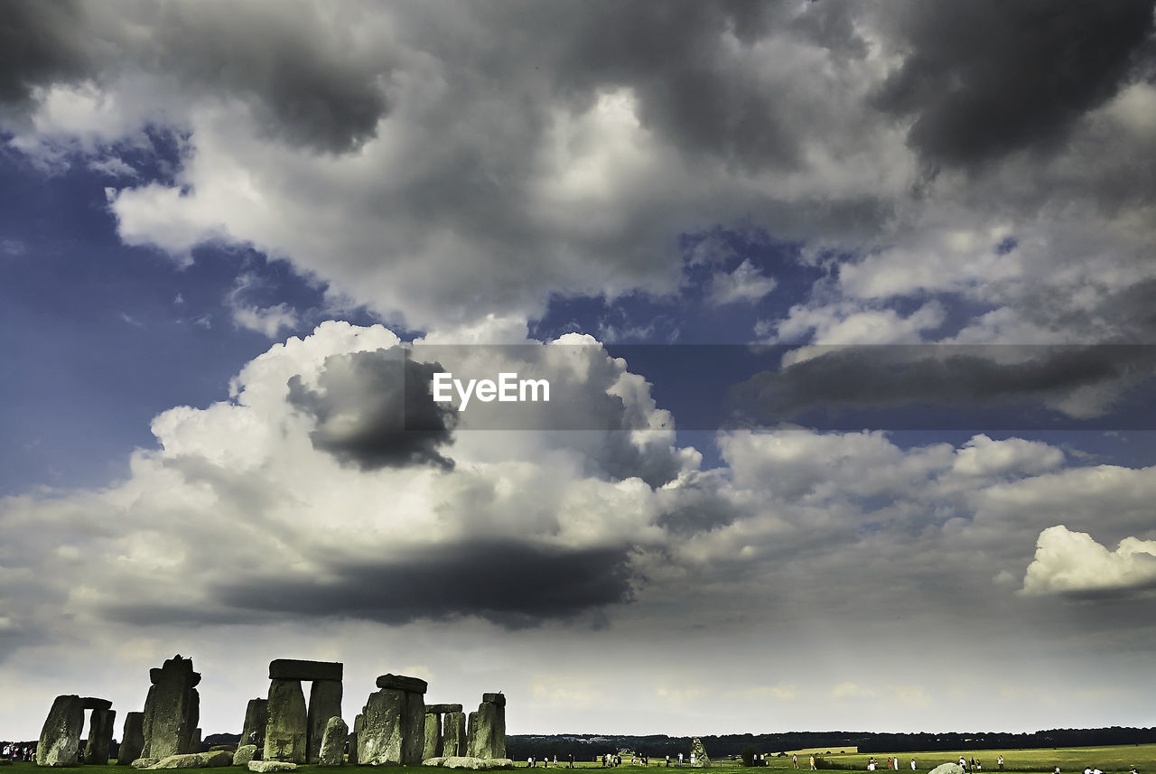 Rocks at stonehenge against cloudy sky