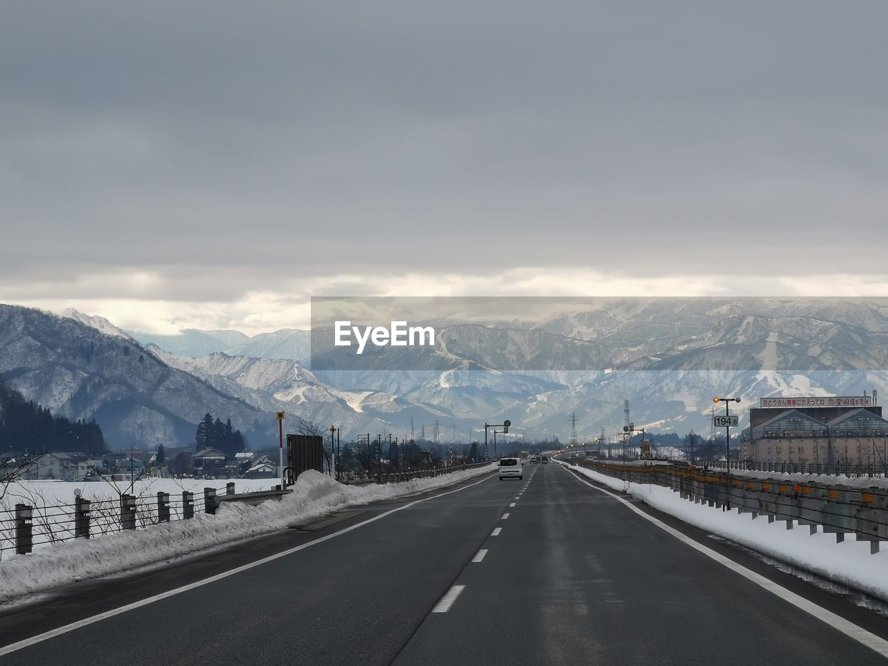 ROAD BY SNOWCAPPED MOUNTAIN AGAINST SKY