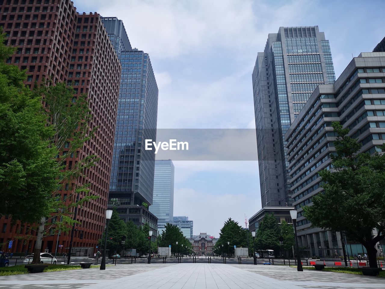 CITY STREET AMIDST BUILDINGS AGAINST SKY