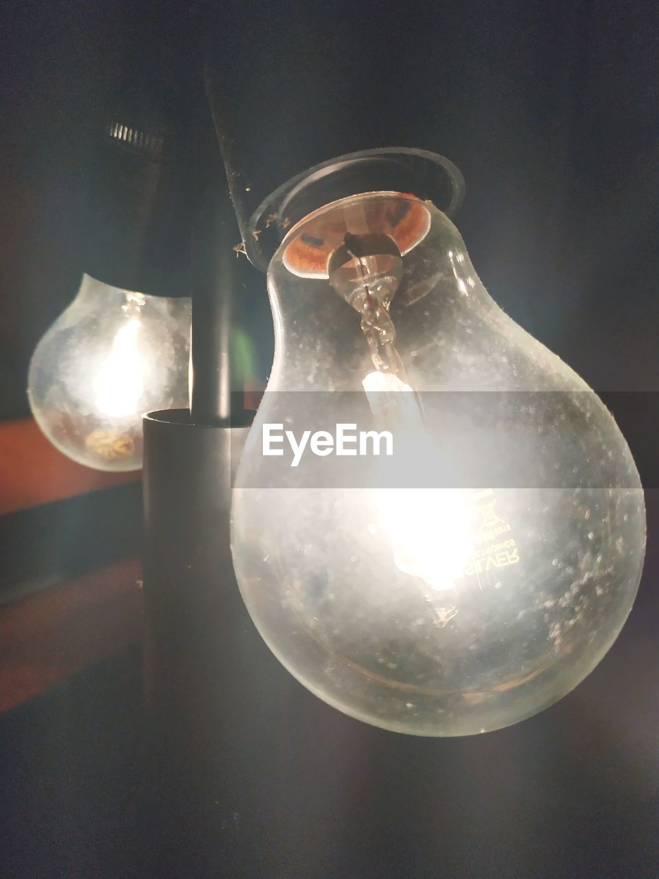 CLOSE-UP OF ILLUMINATED LIGHT BULBS ON TABLE