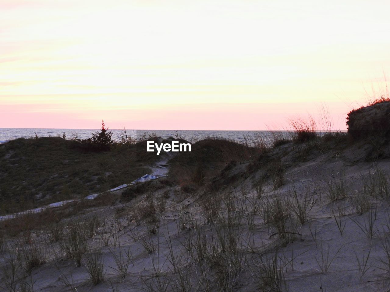 SCENIC VIEW OF SEA AGAINST ORANGE SKY