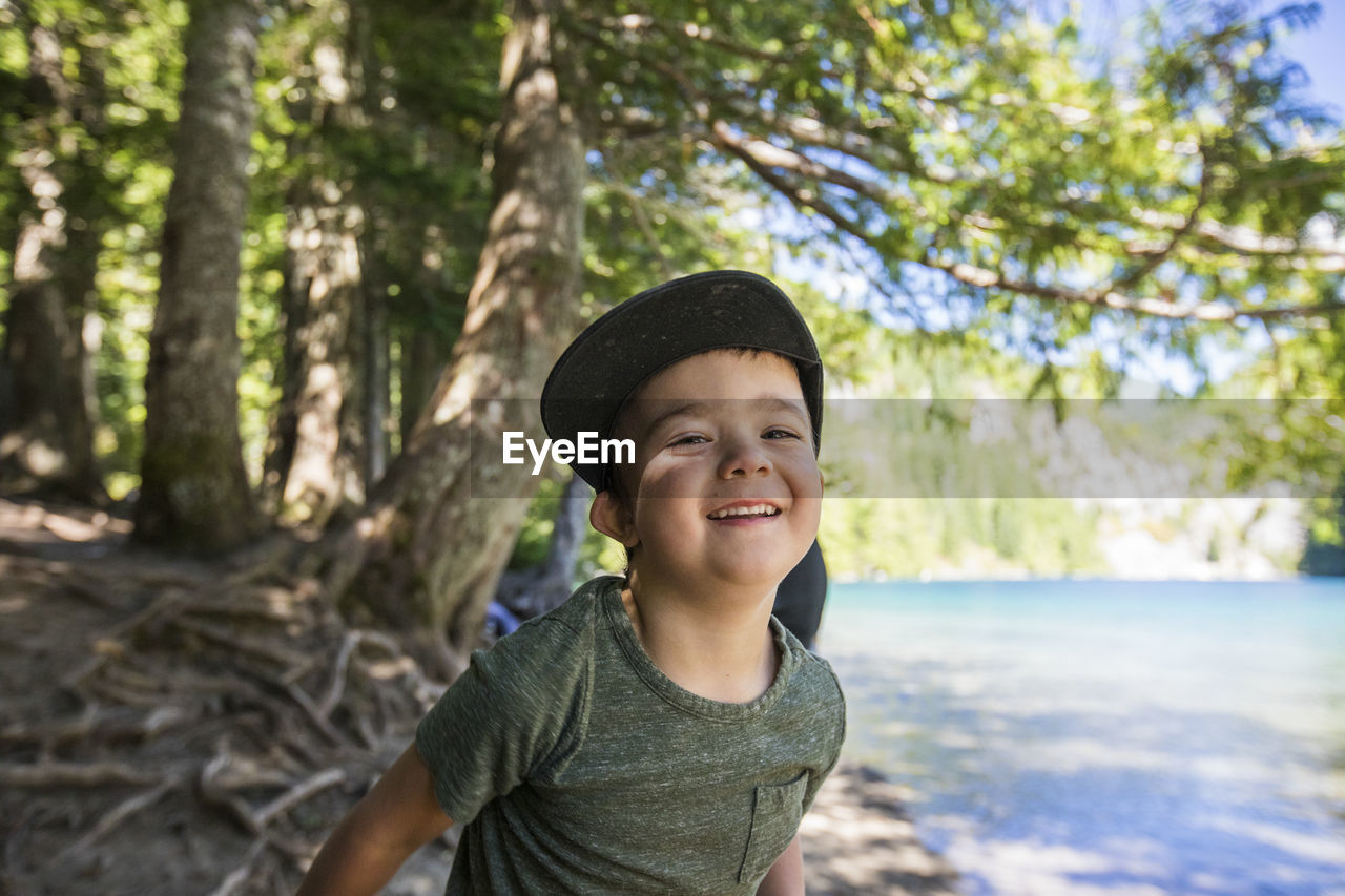 Portrait of happy four year old boy at lindeman lake, chilliwack, b.c.