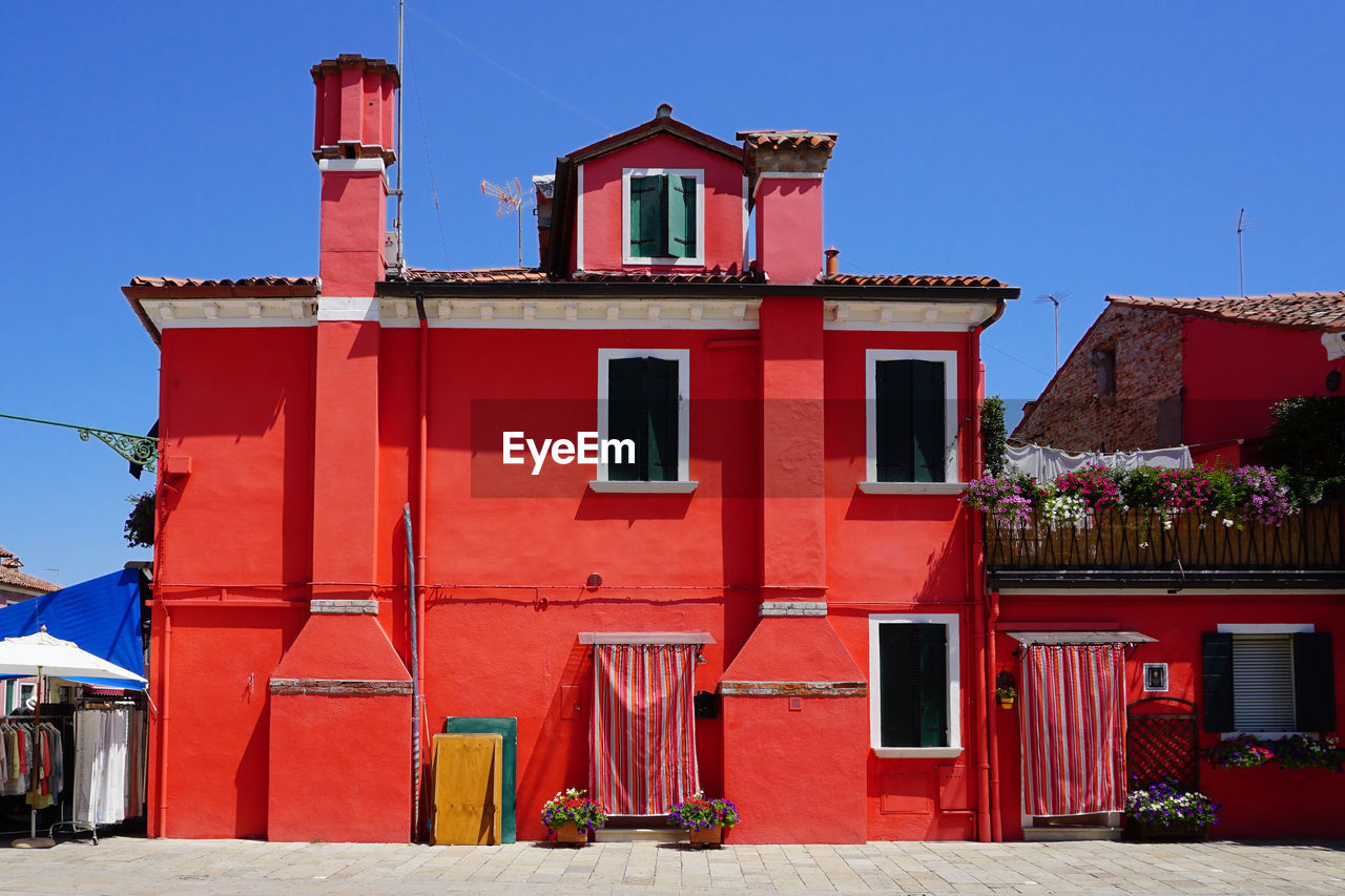 Burano colorful building architecture in red, venice, italy, europe