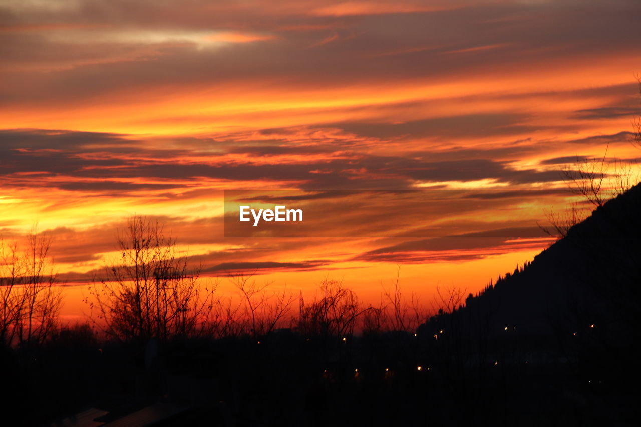 SCENIC VIEW OF DRAMATIC SKY OVER SILHOUETTE LANDSCAPE