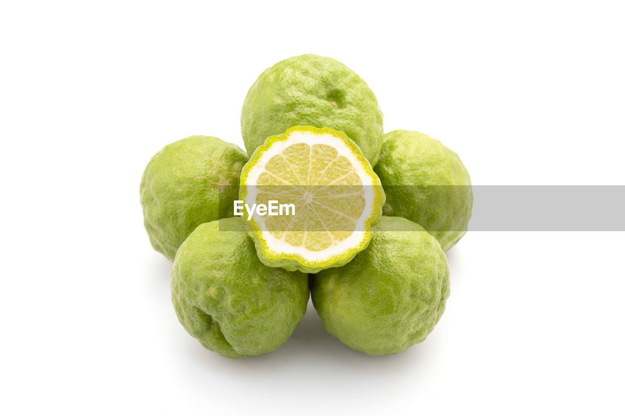 food and drink, food, healthy eating, fruit, lime, freshness, wellbeing, cut out, produce, citrus, studio shot, green, white background, plant, citrus fruit, cross section, slice, indoors, no people, citron, lemon, group of objects, raw food, close-up, organic, vitamin, vegetable