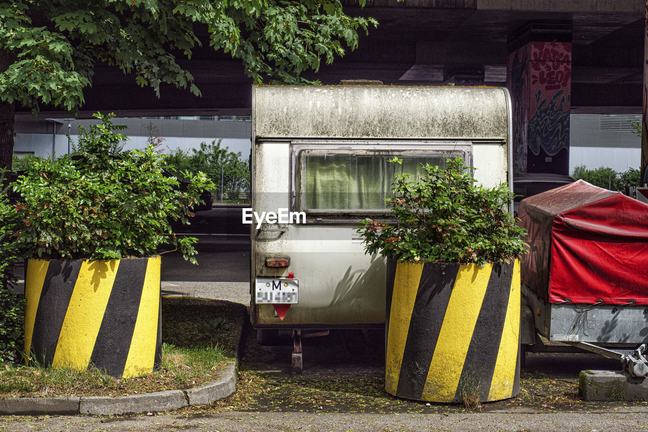 Old and dirty caravan parked under a bridge in the city of munich