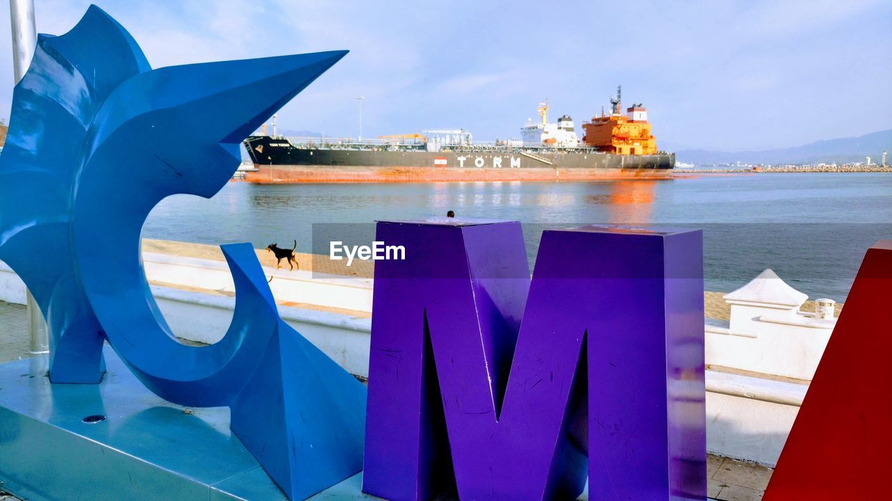 CLOSE-UP OF BOATS MOORED IN SEA