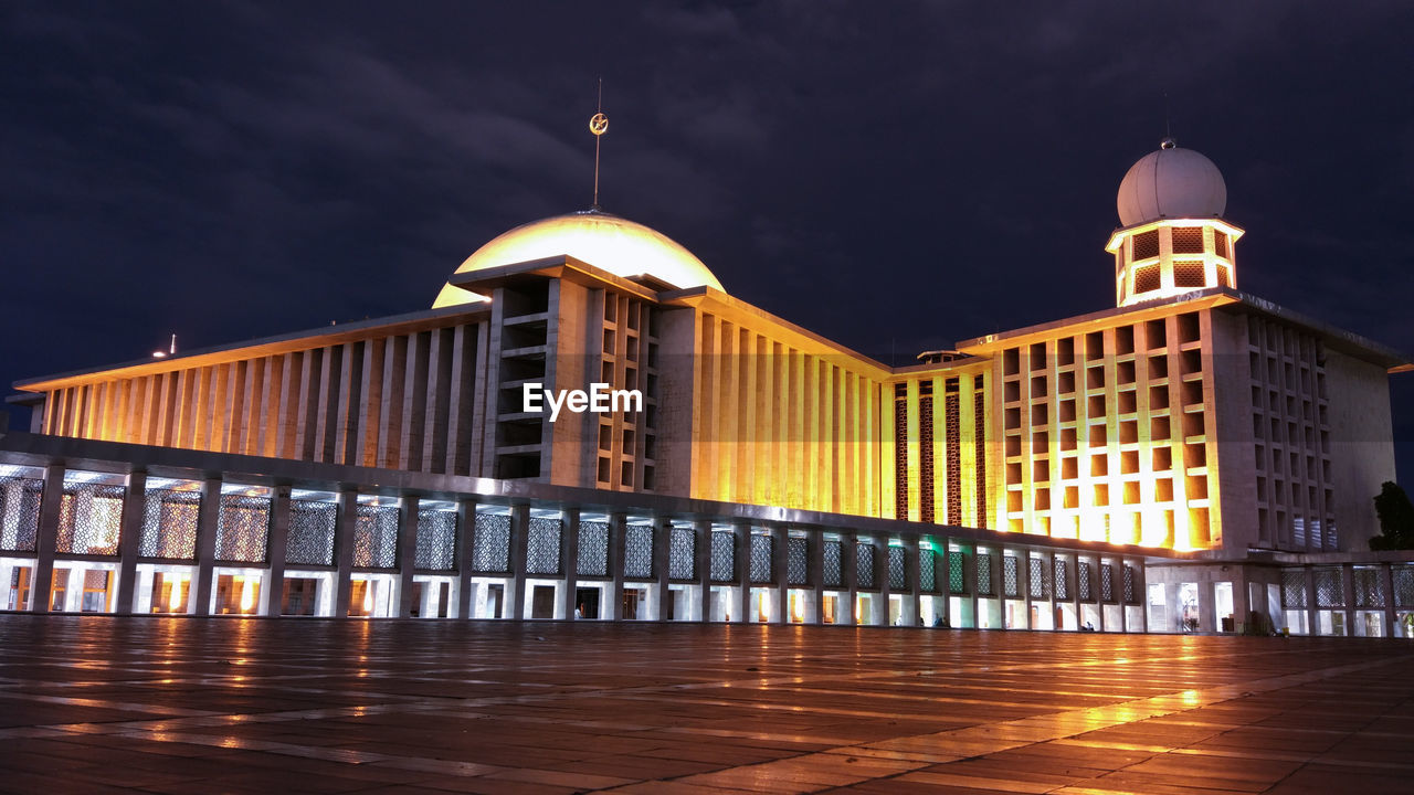 Illuminated building against sky at night