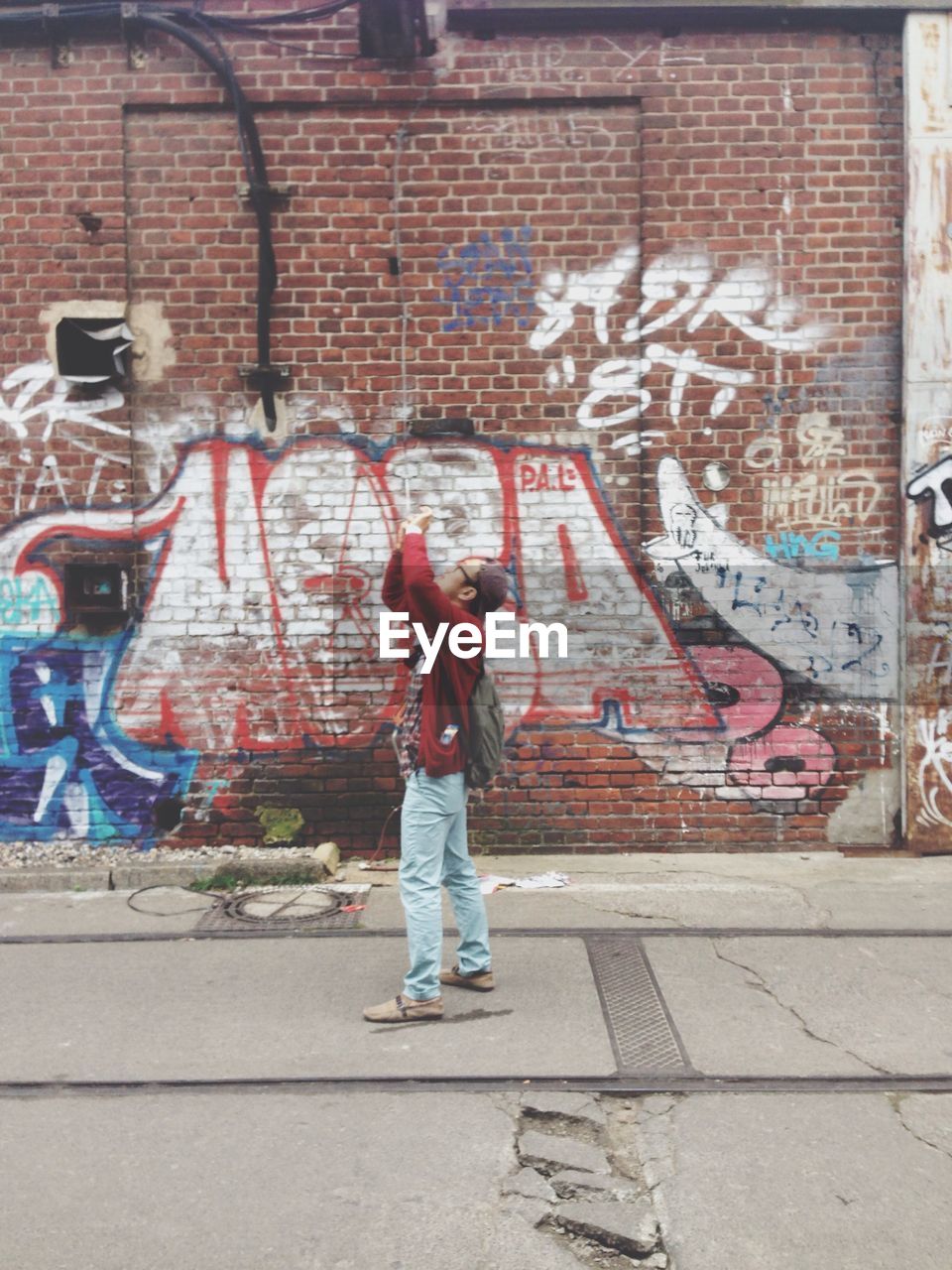 MAN STANDING ON WALL