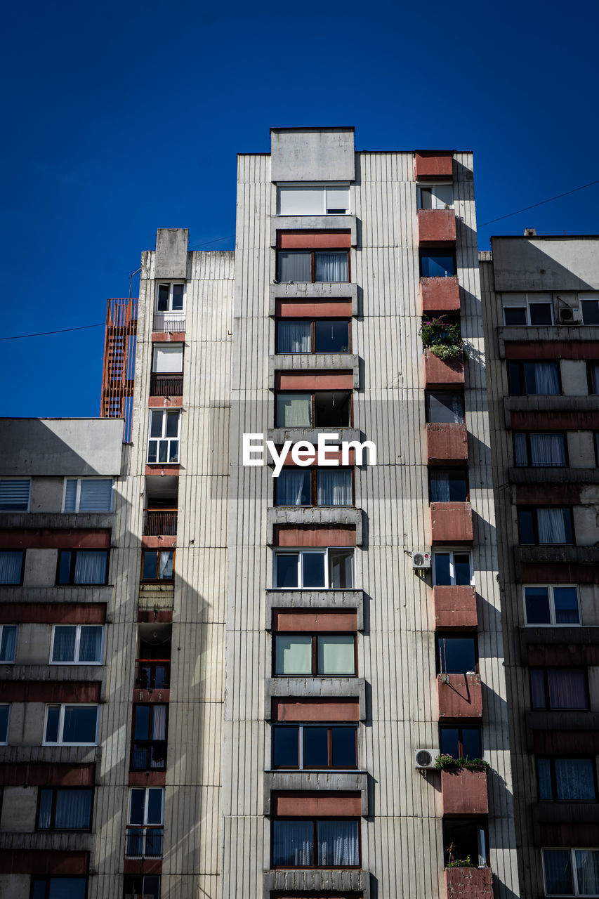 Low angle view of buildings against clear blue sky old ussr