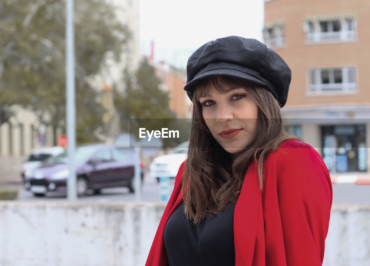 Portrait of beautiful young woman in city