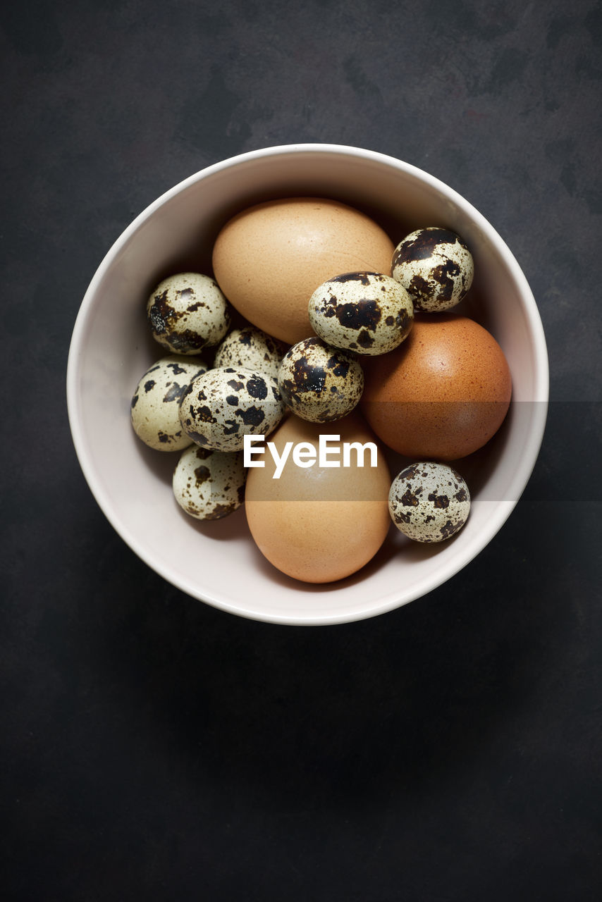 Quail and chicken eggs on a bowl.