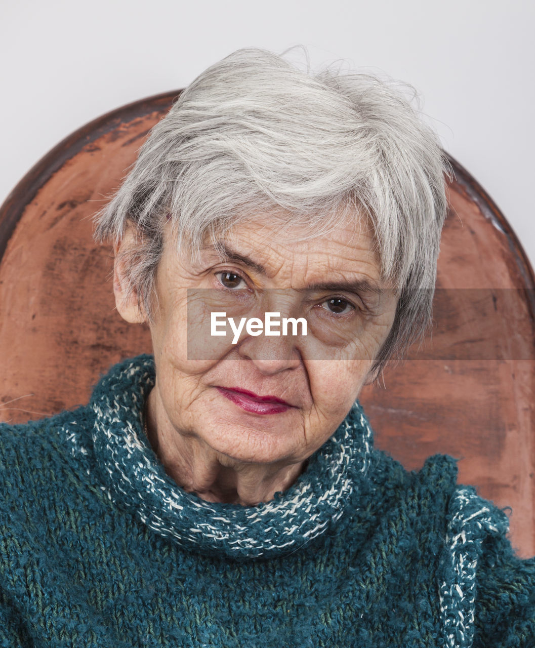 Close-up portrait of senior woman sitting on chair